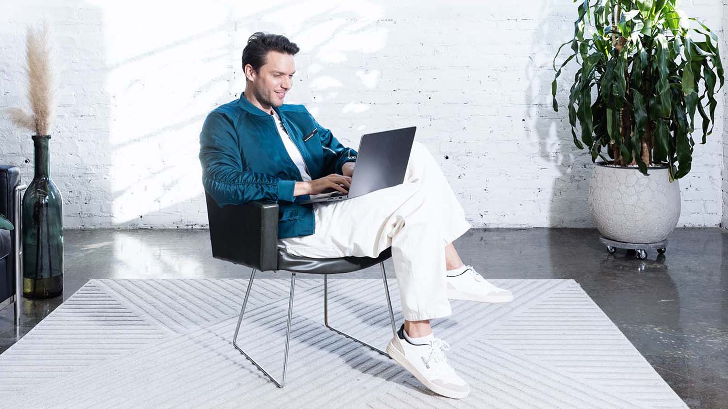 Monatsbudget: Was ist das und warum ist es sinnvoll? Junger Mann arbeitet am Laptop und plant sein Budget.