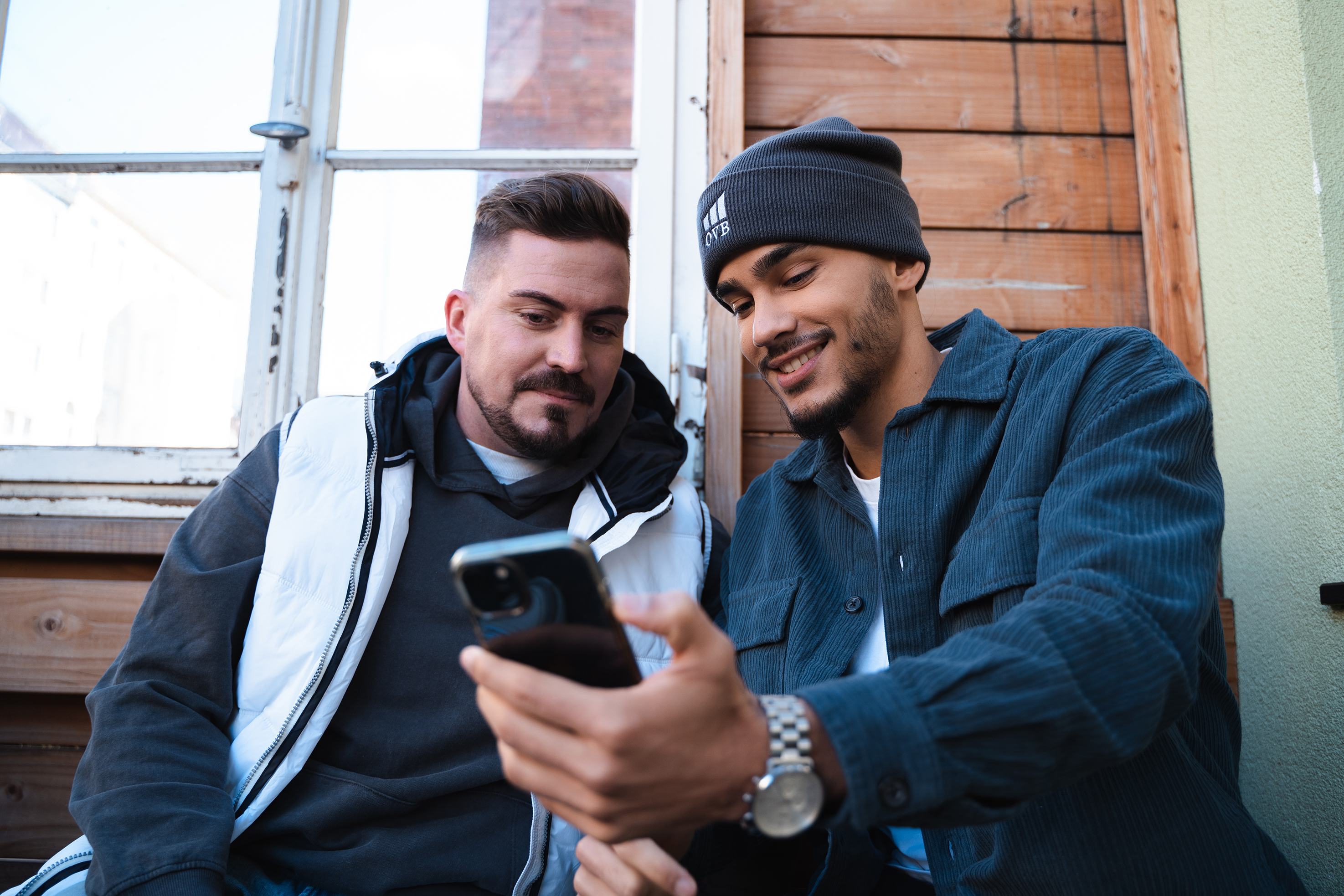zwei Männer schauen auf Smartphone